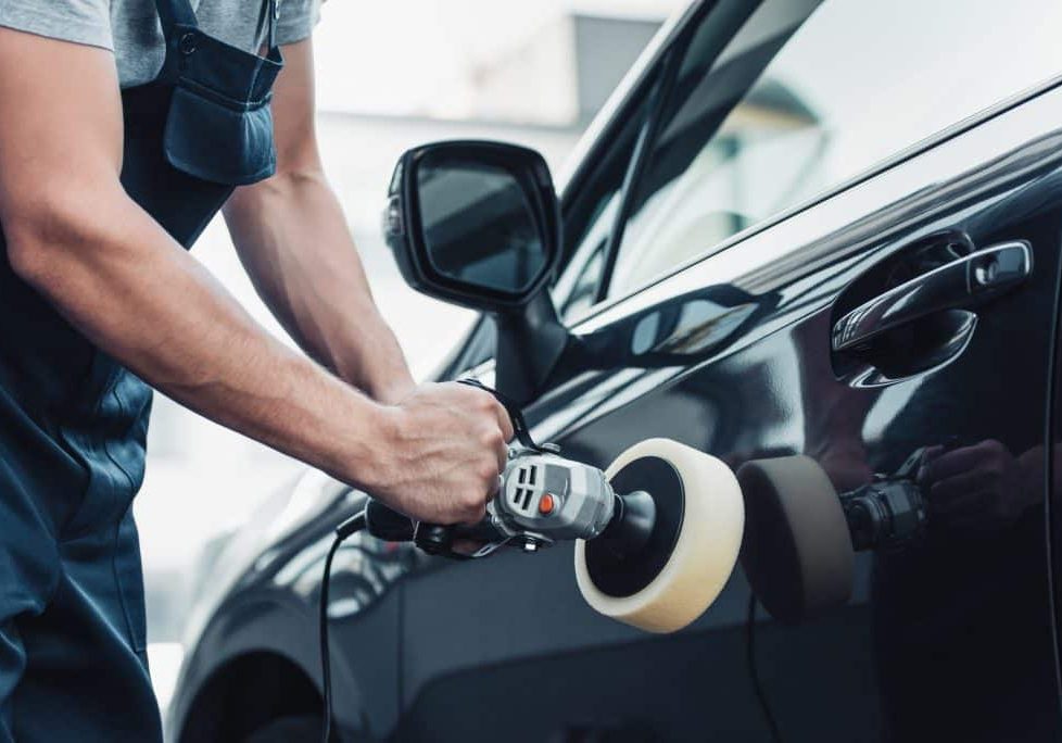 Polishing exterior of car with buffer